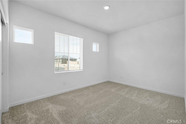 carpeted spare room with recessed lighting and baseboards