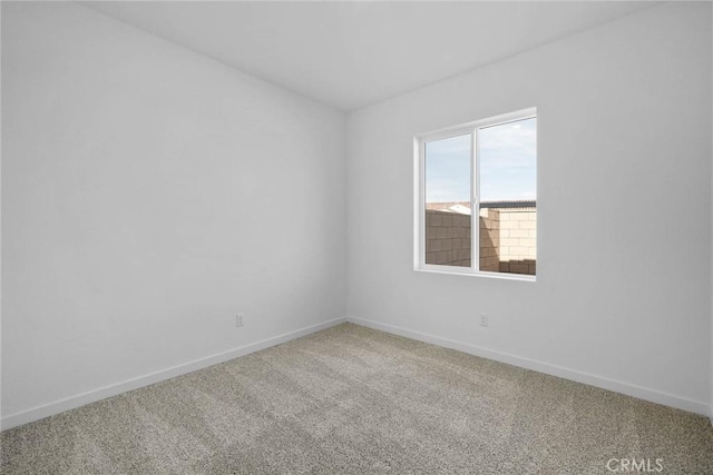 unfurnished room featuring baseboards and carpet floors