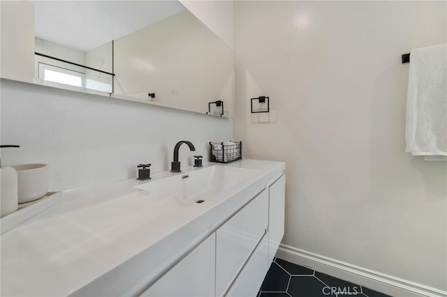 bathroom with tile patterned floors, vanity, and baseboards