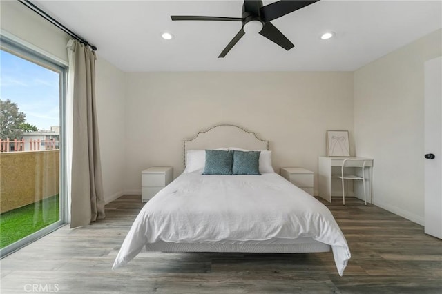 bedroom with access to outside, recessed lighting, wood finished floors, and baseboards