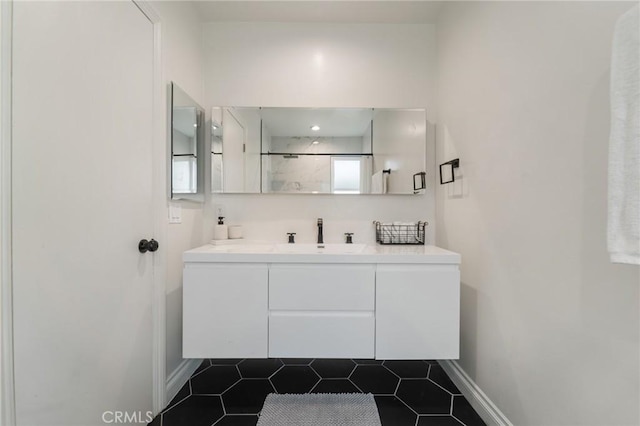 bathroom with vanity, tile patterned floors, a shower, and baseboards