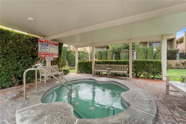 view of swimming pool with a community hot tub