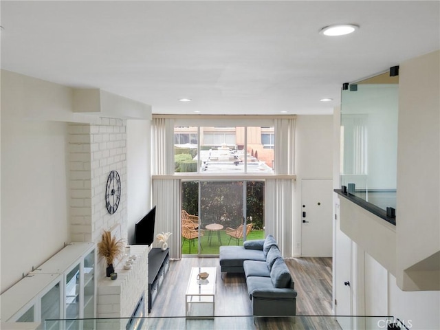 living area with recessed lighting and wood finished floors