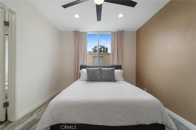 bedroom with ceiling fan, baseboards, wood finished floors, and recessed lighting