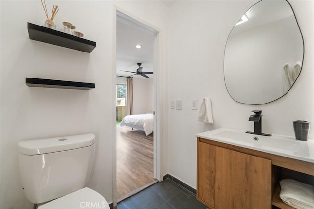 bathroom with vanity, ceiling fan, ensuite bathroom, tile patterned floors, and toilet