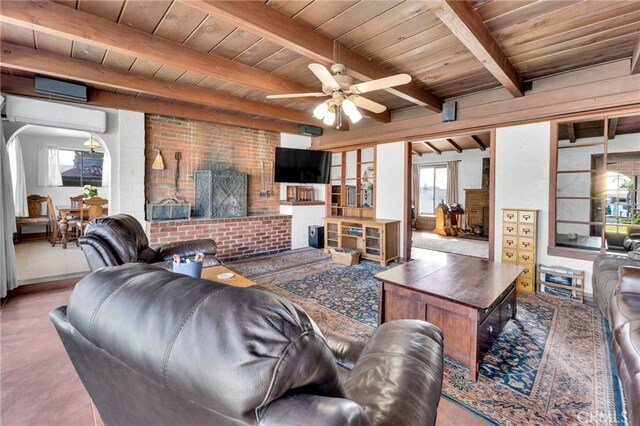 living area with beamed ceiling, wooden ceiling, a wall mounted AC, and ceiling fan