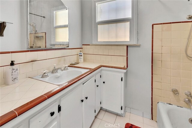 full bath featuring tile patterned floors, backsplash, tub / shower combination, and vanity