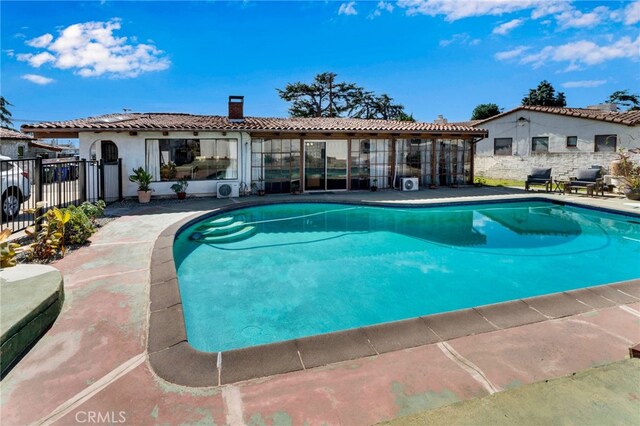 view of pool with a patio area, a fenced in pool, and fence