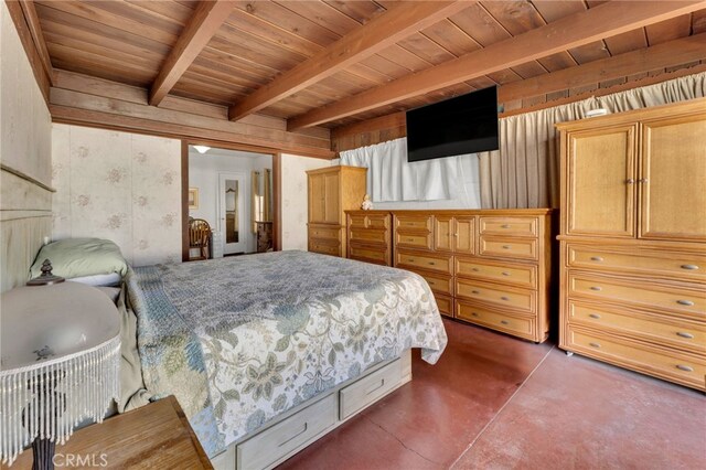 bedroom with wallpapered walls, wooden ceiling, beamed ceiling, and concrete floors