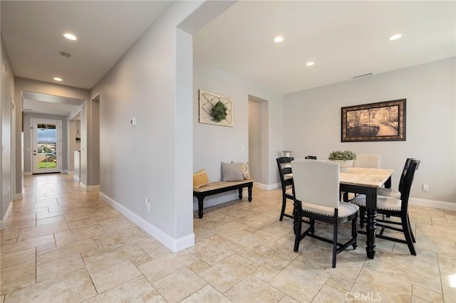 dining space featuring visible vents, recessed lighting, stone finish flooring, and baseboards