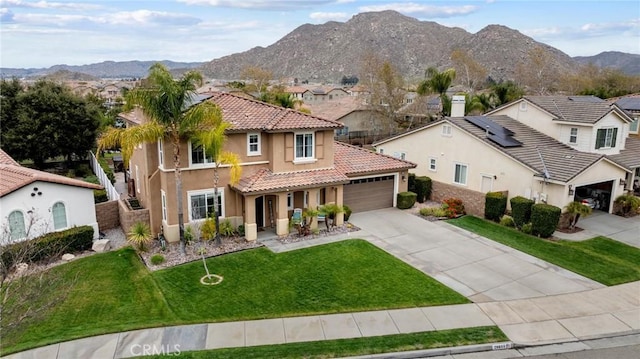 mediterranean / spanish-style home with a residential view, a tile roof, a front yard, stucco siding, and a garage