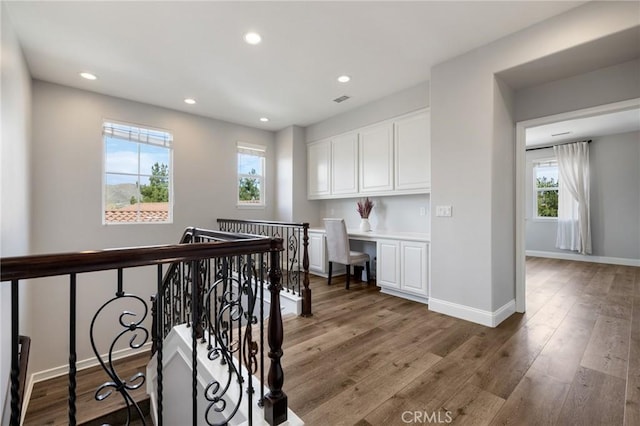 hallway with visible vents, recessed lighting, light wood-style floors, and baseboards