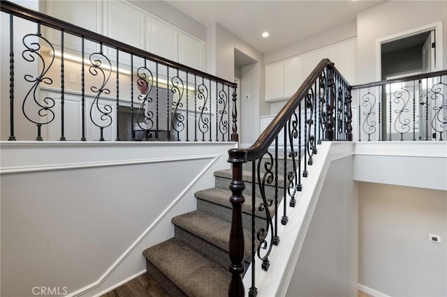 stairway featuring recessed lighting and wood finished floors