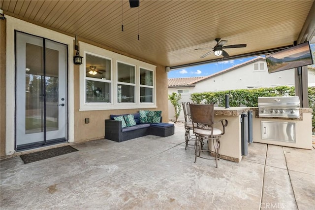 view of patio with outdoor dry bar, an outdoor kitchen, a grill, an outdoor hangout area, and ceiling fan