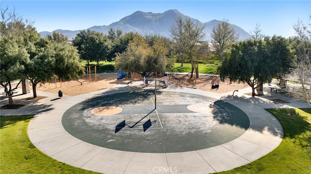 view of home's community with a mountain view and a yard