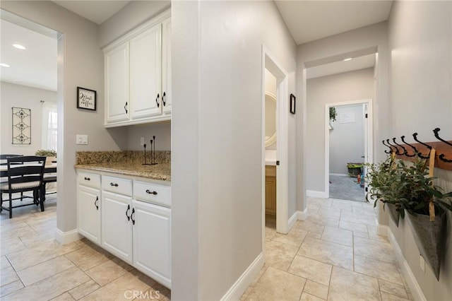 hallway featuring recessed lighting and baseboards