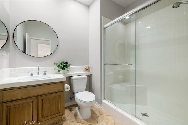 bathroom featuring toilet, a shower stall, and tile patterned flooring