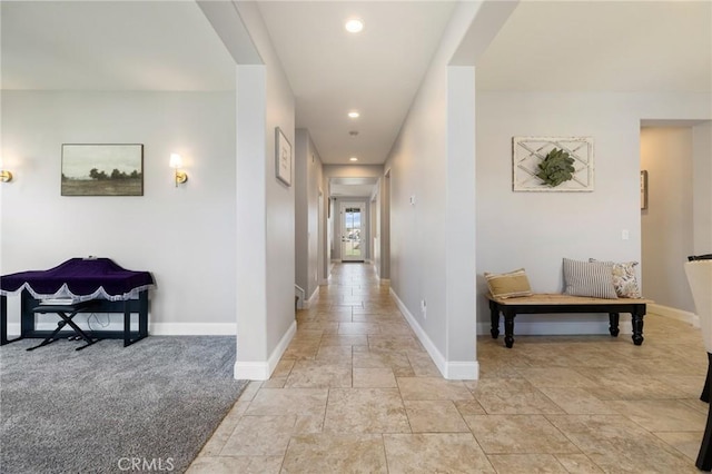 corridor with recessed lighting and baseboards