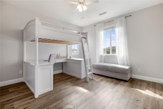 unfurnished bedroom with visible vents, baseboards, light wood-style flooring, and a ceiling fan