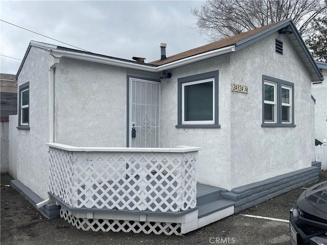 back of house with stucco siding