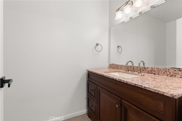 bathroom with vanity and baseboards