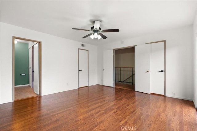 unfurnished bedroom with visible vents, a ceiling fan, and wood finished floors