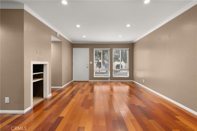 interior space with baseboards, light wood-type flooring, and ornamental molding