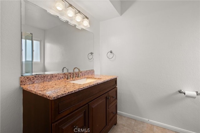 bathroom featuring tile patterned flooring, vanity, and baseboards