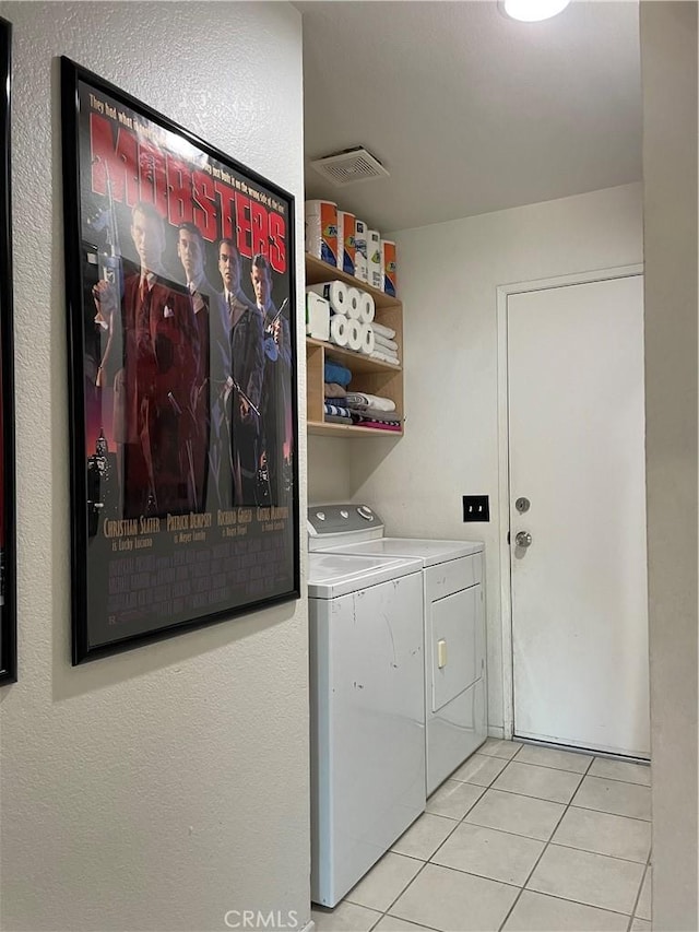 laundry room with light tile patterned floors, visible vents, independent washer and dryer, and laundry area