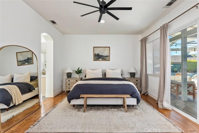 bedroom with visible vents, light wood-style flooring, and access to outside