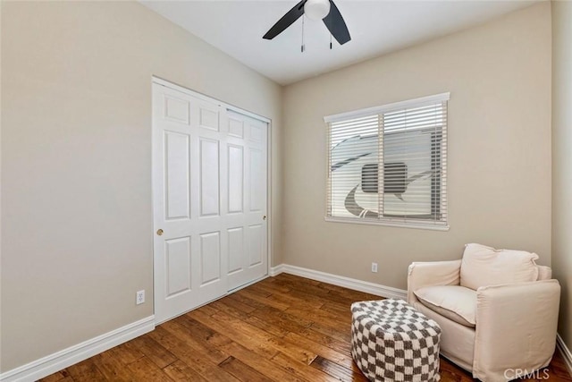 sitting room featuring wood finished floors, baseboards, and ceiling fan