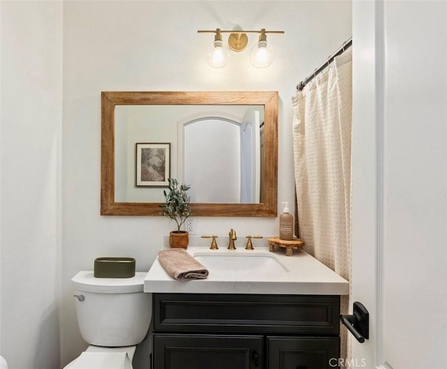 bathroom featuring toilet and vanity