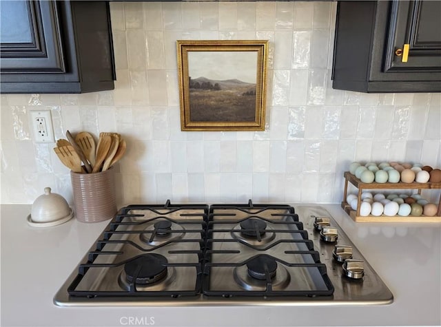 interior details featuring stainless steel gas cooktop and decorative backsplash