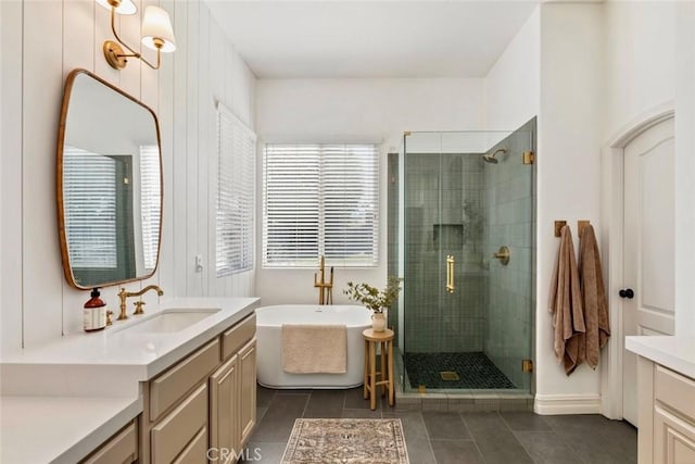 full bathroom featuring a soaking tub, vanity, a shower stall, and tile patterned flooring