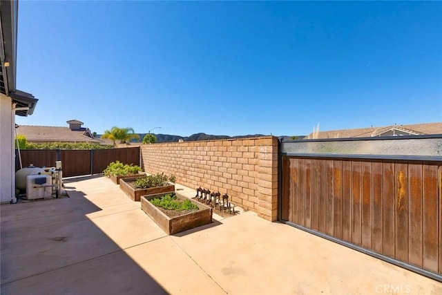 view of patio / terrace featuring a vegetable garden and a fenced backyard