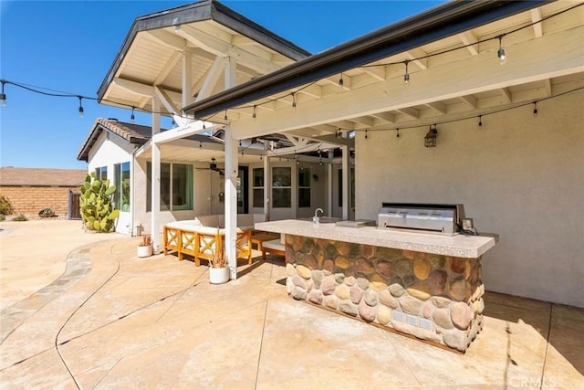 view of patio / terrace with an outdoor kitchen, a grill, and a ceiling fan