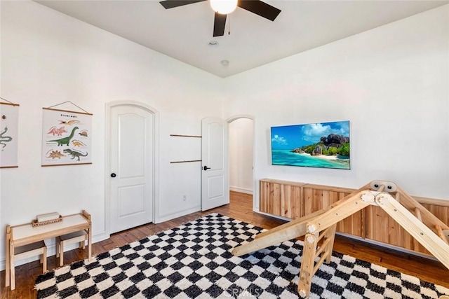 interior space with a ceiling fan and wood finished floors