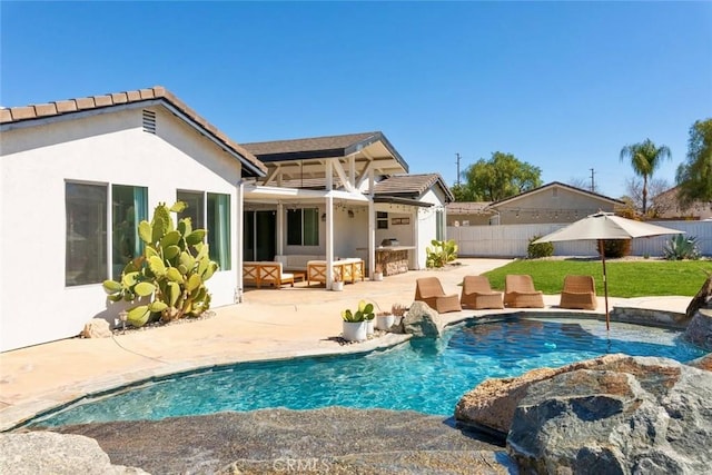 back of house with a patio area, fence, a fenced in pool, and stucco siding