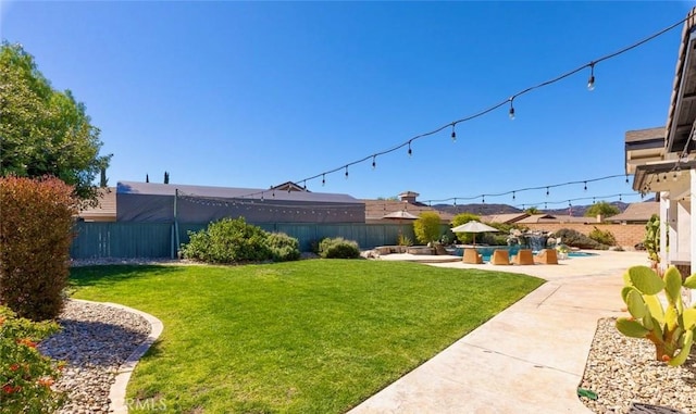 view of yard featuring a patio and a fenced backyard