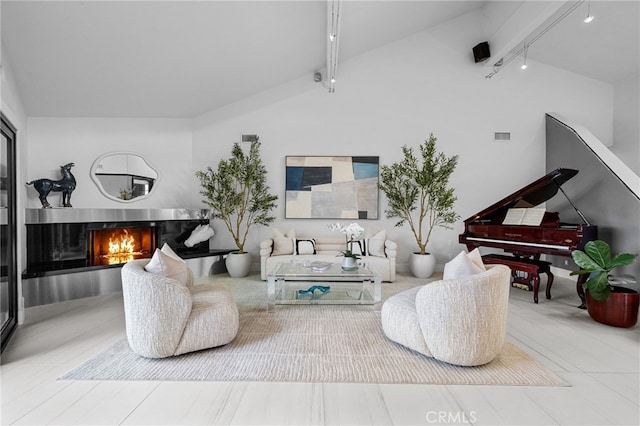 32252 Azores Rd, Dana Point, CA 92629 - living area featuring lofted ceiling with beams, a lit fireplace, rail lighting, and visible vents