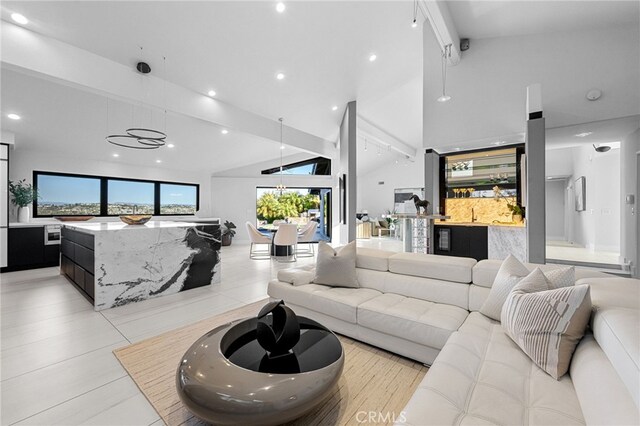 living room with recessed lighting, beam ceiling, bar area, and high vaulted ceiling