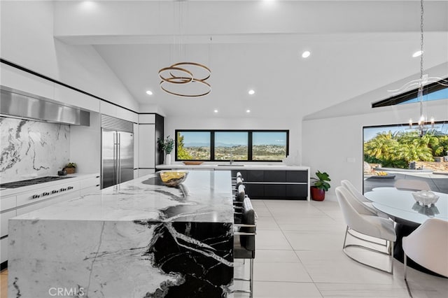 32252 Azores Rd, Dana Point, CA 92629 - kitchen featuring white stovetop, decorative backsplash, modern cabinets, and stainless steel built in refrigerator