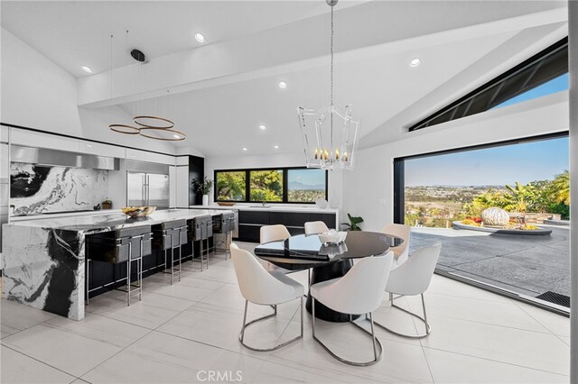 dining room featuring a notable chandelier, recessed lighting, and high vaulted ceiling