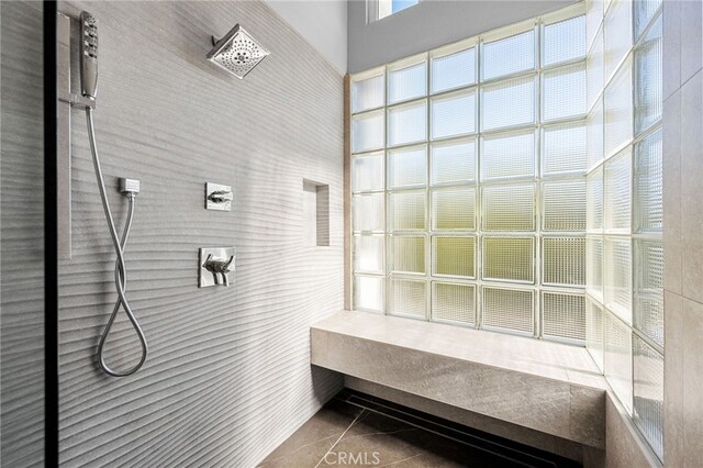 full bath with tile patterned flooring and tiled shower