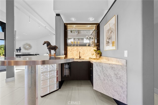 bar featuring wet bar, tile patterned floors, and a sink