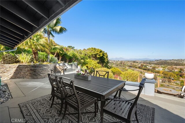 view of patio featuring outdoor dining space and a mountain view