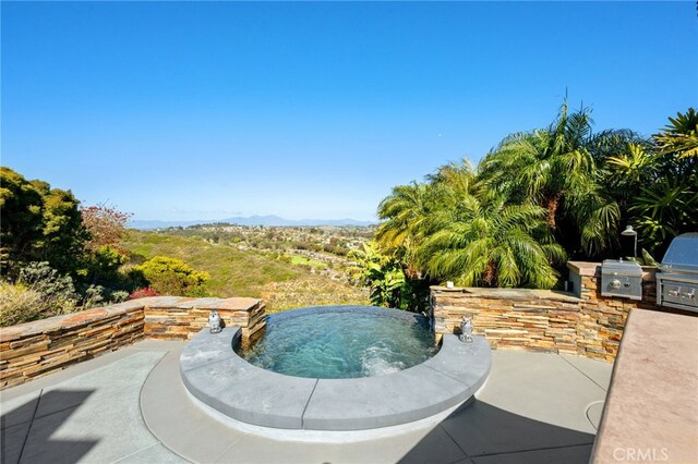 view of pool featuring area for grilling, an in ground hot tub, and a patio