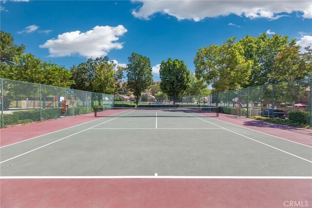 view of sport court with fence