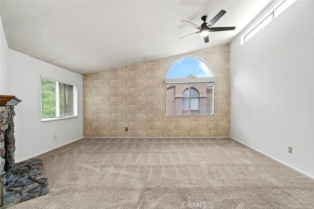 unfurnished living room with carpet flooring, a fireplace, and vaulted ceiling