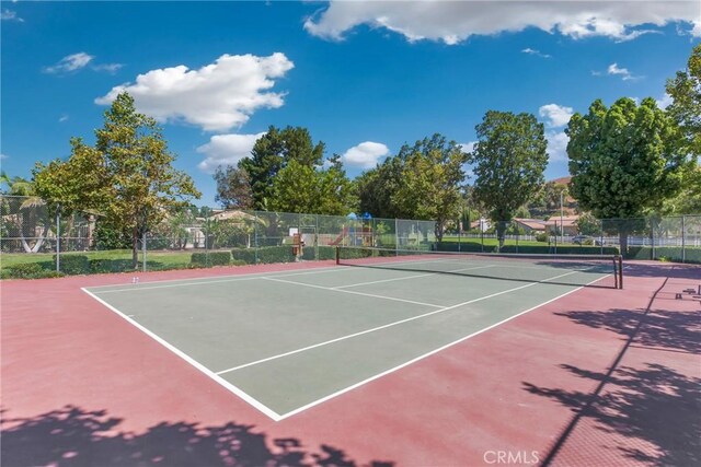 view of sport court with fence